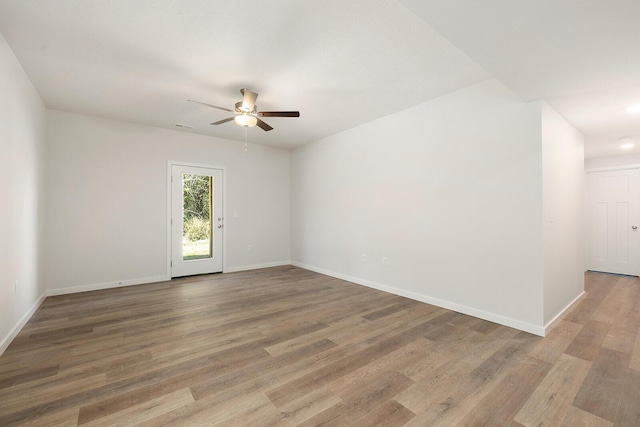 unfurnished room with hardwood / wood-style flooring and ceiling fan