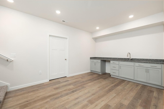 kitchen featuring sink, gray cabinets, and light hardwood / wood-style floors