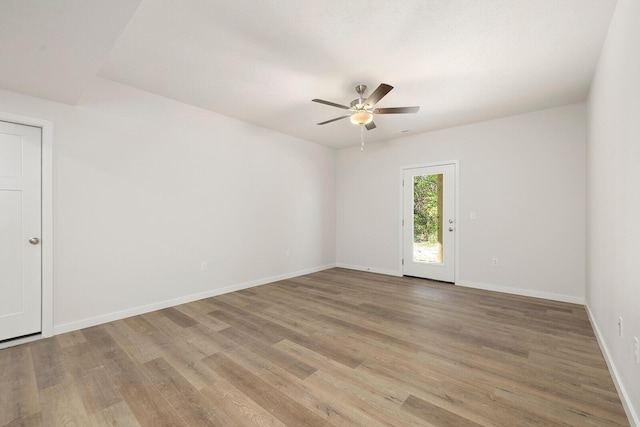 spare room featuring light hardwood / wood-style flooring and ceiling fan