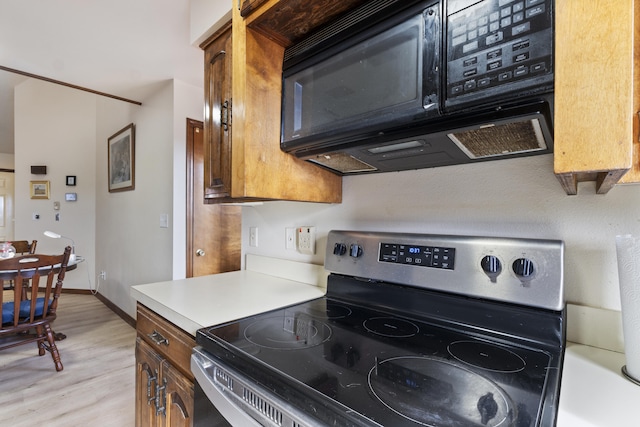 kitchen with light wood-type flooring and electric stove