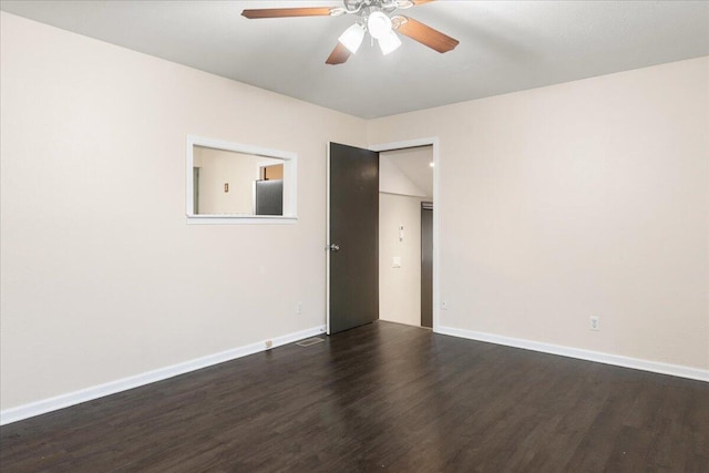 spare room with ceiling fan and dark hardwood / wood-style flooring