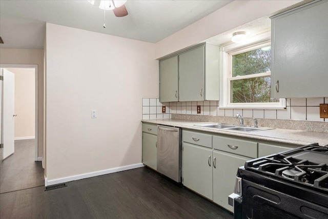 kitchen with dark hardwood / wood-style floors, range with gas stovetop, sink, backsplash, and stainless steel dishwasher