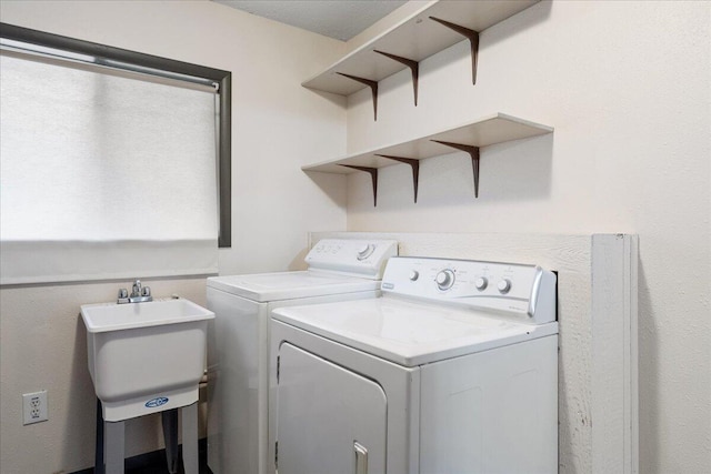 clothes washing area with sink and washing machine and dryer