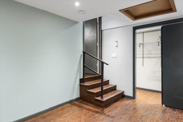 staircase with wood-type flooring