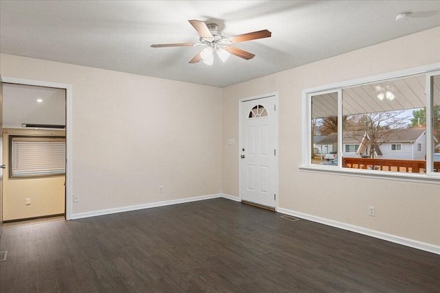 unfurnished room featuring dark wood-type flooring and ceiling fan