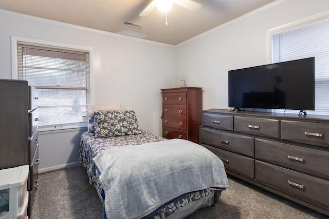 bedroom featuring ornamental molding, a textured ceiling, ceiling fan, and dark carpet