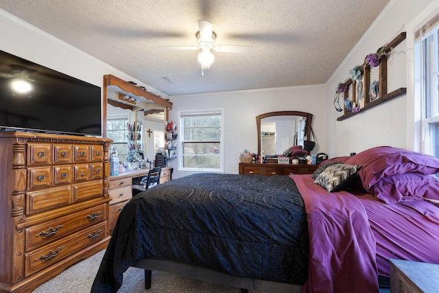 bedroom featuring ornamental molding, a textured ceiling, and carpet flooring