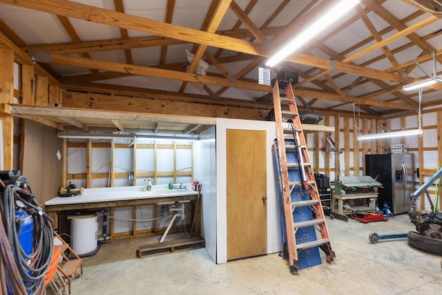 miscellaneous room featuring a workshop area and concrete floors