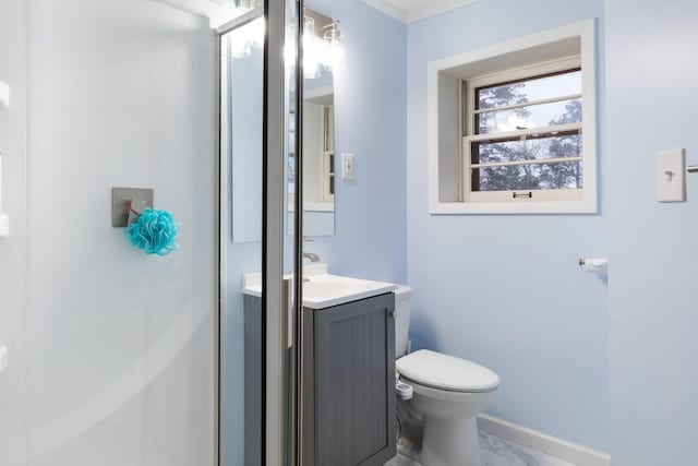 bathroom with vanity, an enclosed shower, and toilet