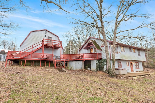 back of property featuring a deck and a patio area