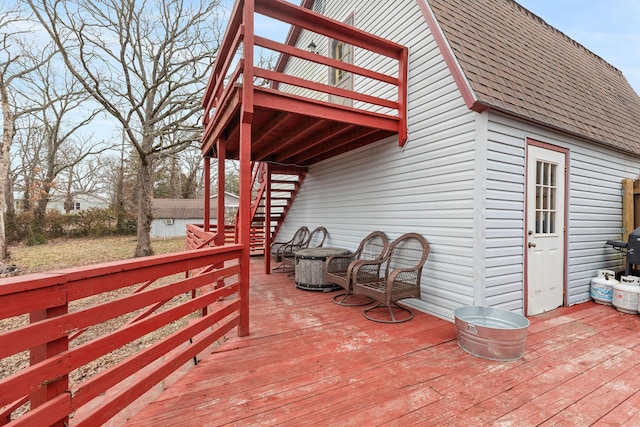 wooden deck featuring a storage unit