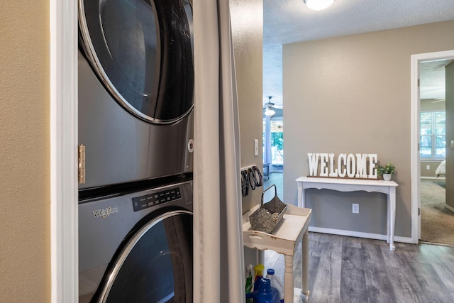 130 A St, Taneyville, MO 65759 - washroom with stacked washing maching and dryer, dark hardwood / wood-style floors, and a textured ceiling