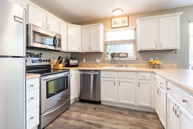 130 A St, Taneyville, MO 65759 - kitchen featuring sink, light hardwood / wood-style flooring, stainless steel appliances, and white cabinets