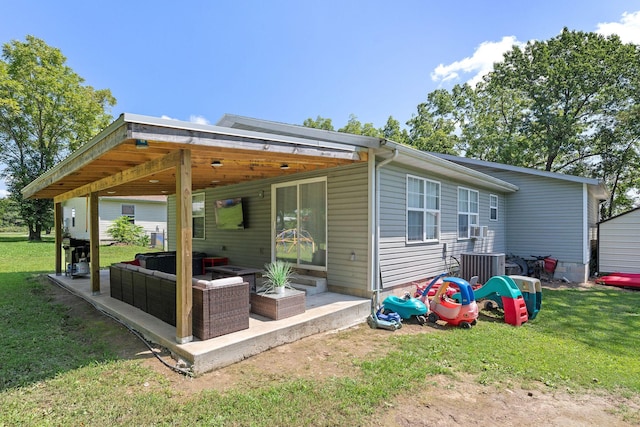130 A St, Taneyville, MO 65759 - rear view of house featuring cooling unit, a patio, an outdoor hangout area, and a lawn