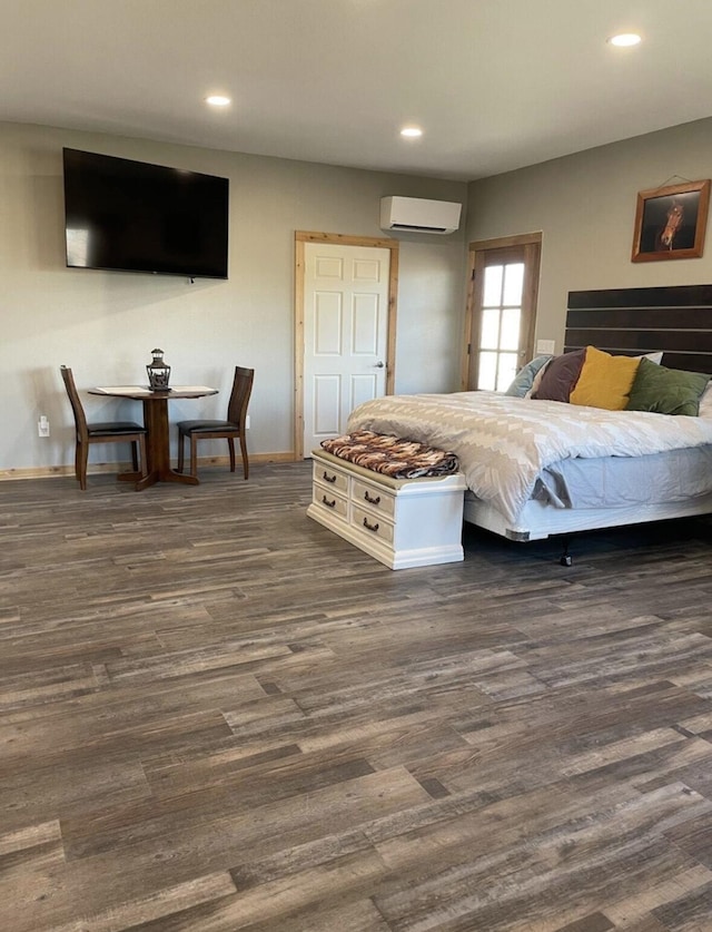 bedroom featuring dark hardwood / wood-style floors and a wall mounted air conditioner