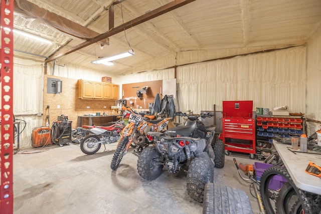 garage featuring electric panel and a workshop area