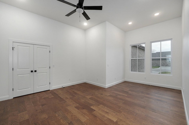 spare room with dark hardwood / wood-style floors and ceiling fan