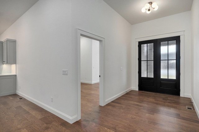 entrance foyer featuring dark hardwood / wood-style floors and french doors