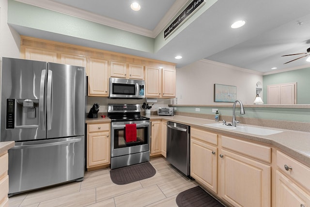 kitchen featuring sink, ceiling fan, stainless steel appliances, ornamental molding, and light brown cabinets