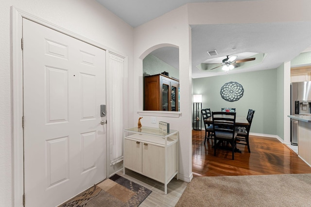 foyer with ceiling fan and wood-type flooring