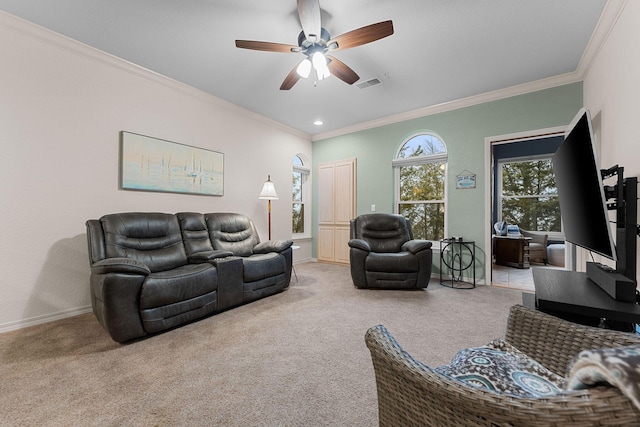 carpeted living room with crown molding and ceiling fan