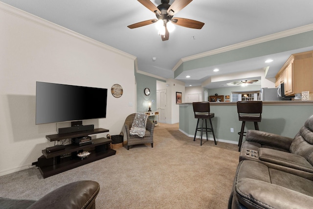 carpeted living room featuring ornamental molding and ceiling fan