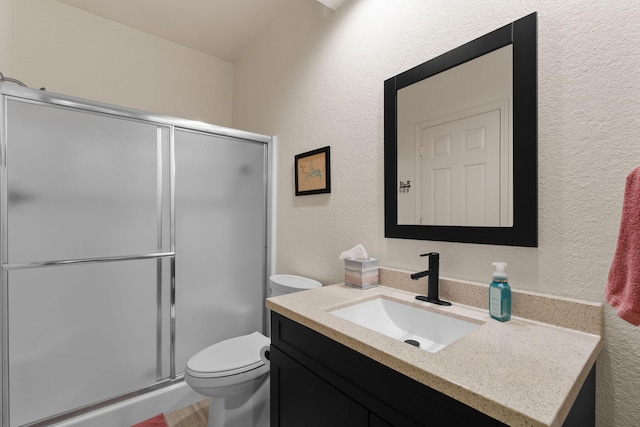 bathroom with vanity, an enclosed shower, and toilet