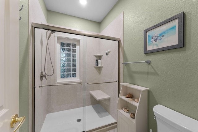 bathroom with walk in shower and toilet