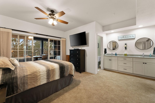 carpeted bedroom with ceiling fan and sink