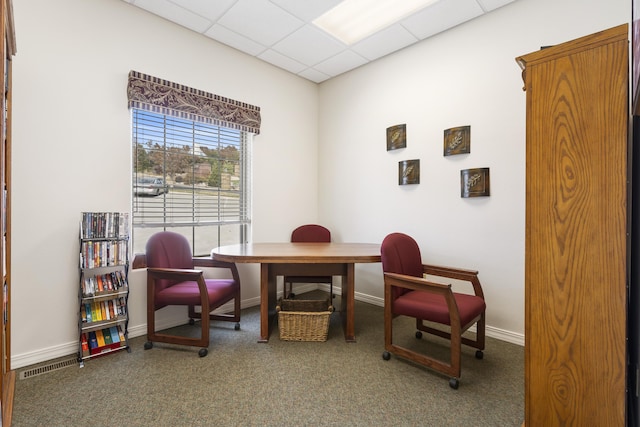 sitting room with carpet and a drop ceiling