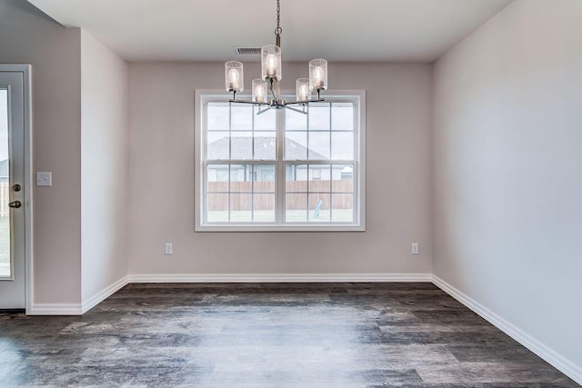 unfurnished dining area featuring dark hardwood / wood-style floors and a notable chandelier