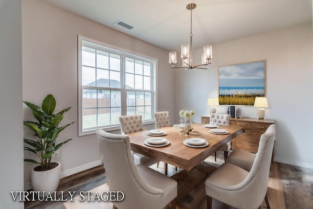 dining area featuring an inviting chandelier and dark hardwood / wood-style flooring