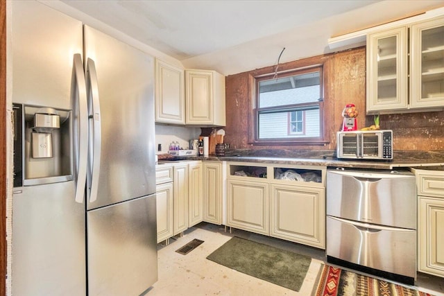 kitchen with tasteful backsplash, stainless steel refrigerator with ice dispenser, dishwashing machine, and cream cabinetry