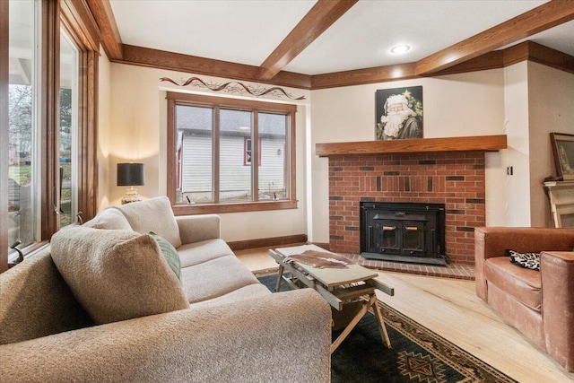 living room with hardwood / wood-style flooring, a fireplace, and beamed ceiling