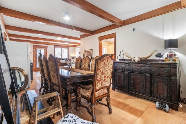 dining space featuring beam ceiling