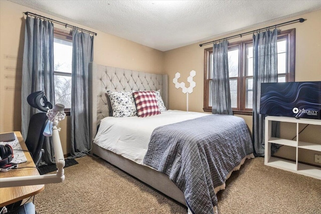 bedroom featuring carpet flooring and a textured ceiling