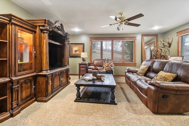 carpeted living room featuring ceiling fan