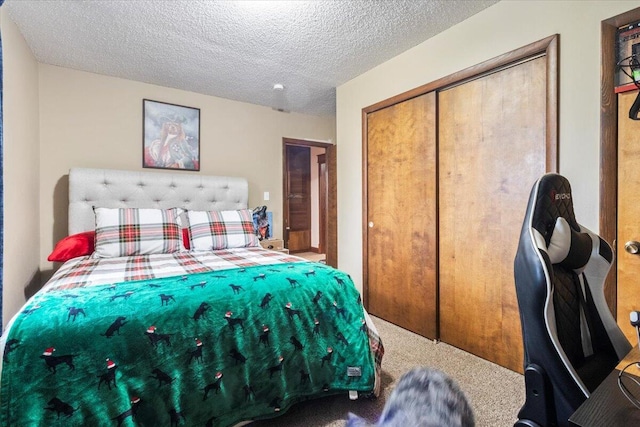 carpeted bedroom featuring a closet and a textured ceiling