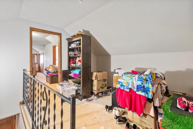 bonus room with lofted ceiling and a textured ceiling