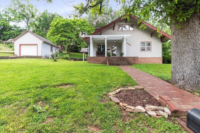 433 S Hill St, West Plains, MO 65775 - view of front of home featuring covered porch, a front yard, an outdoor structure, and a garage