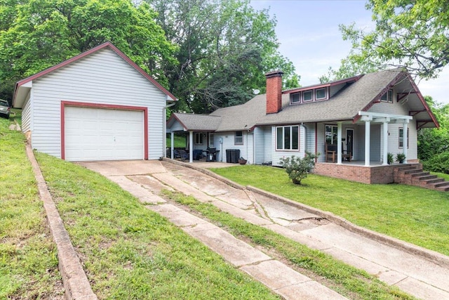 433 S Hill St, West Plains, MO 65775 - view of front facade with covered porch, concrete driveway, a front yard, and a chimney