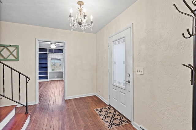 entrance foyer with a notable chandelier and dark wood-type flooring