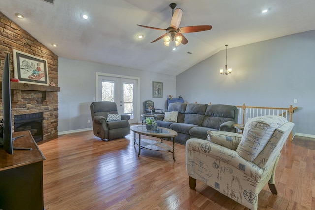 living room with lofted ceiling, light hardwood / wood-style floors, and french doors