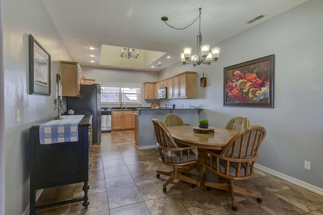 dining space with a chandelier and sink