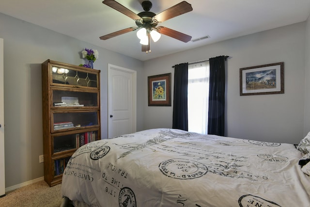 bedroom featuring light carpet and ceiling fan