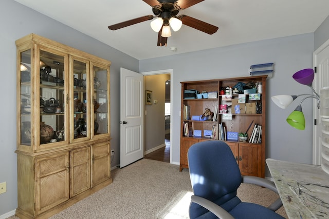 office space featuring ceiling fan and light carpet