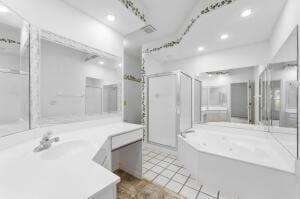 bathroom featuring tile patterned floors, vanity, and separate shower and tub