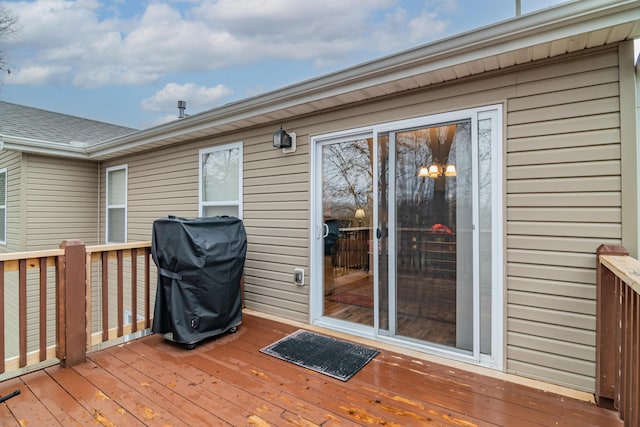 wooden terrace featuring a grill