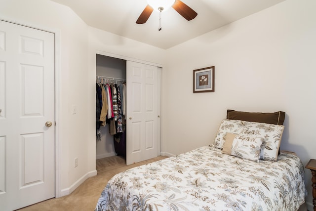 bedroom with ceiling fan, light carpet, and a closet