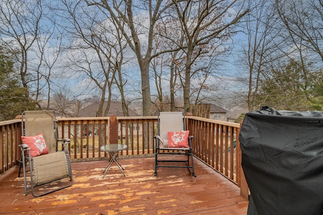 wooden deck featuring a grill